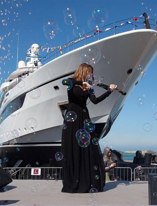 Woman at launch of superyacht DRAGON