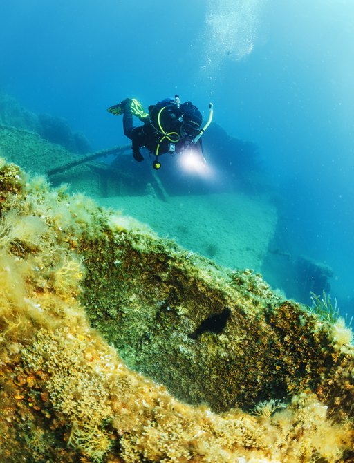 Scuba diver examines a wreck in Greece