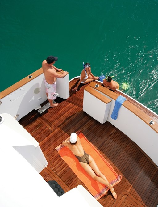 charter guests get close to the Australian waters on the swim platform of charter yacht ‘Emerald Lady’