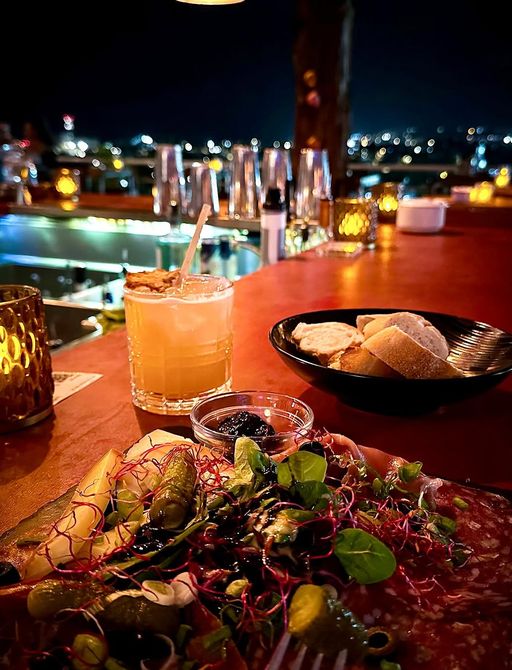 Cocktail and snacks on bar at Cloud Rooftop Bar