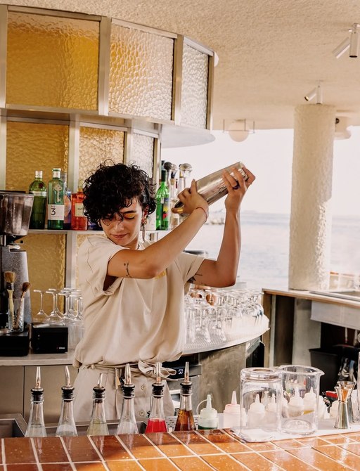 Bar team member mixing cocktails