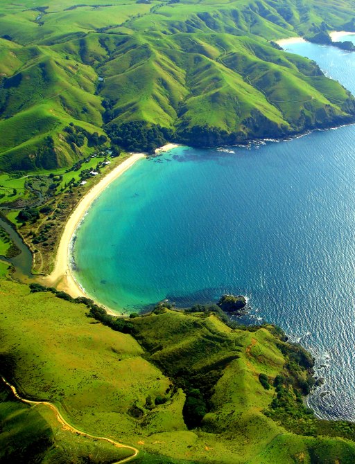 Beatiful beach, green hills and blue waters at Taupo Bay, New Zealand