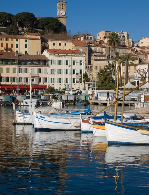 Cannes port with small sail boats and charming buildings