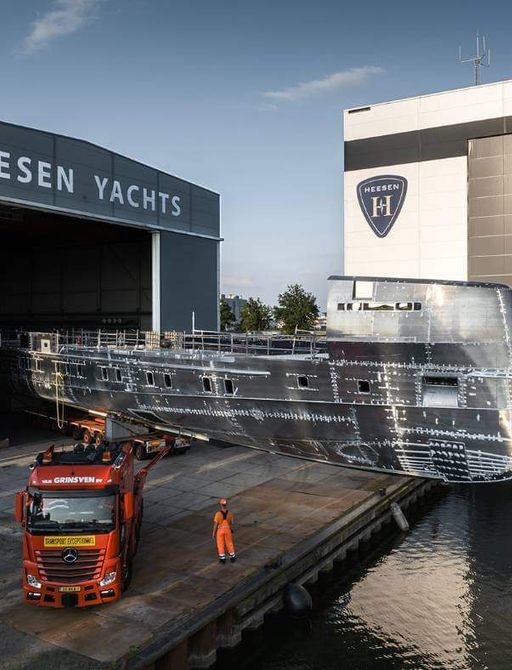 Side view of the unpainted hull of Heesen's inbuild superyacht Project Orion, emerging out of the construction shed.