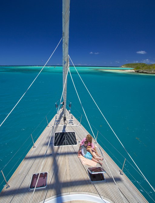 guests relax on foredeck of charter yacht JUPITER