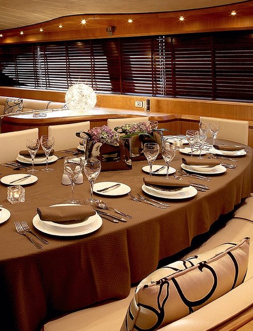 table set for dinner in main salon of charter yacht ‘Paris A’ 