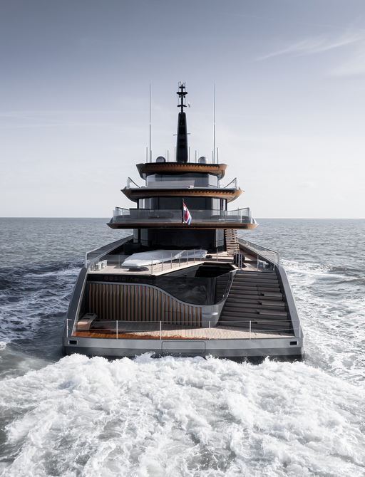 Aft view of superyacht OBSIDIAN underway, surrounded by sea.