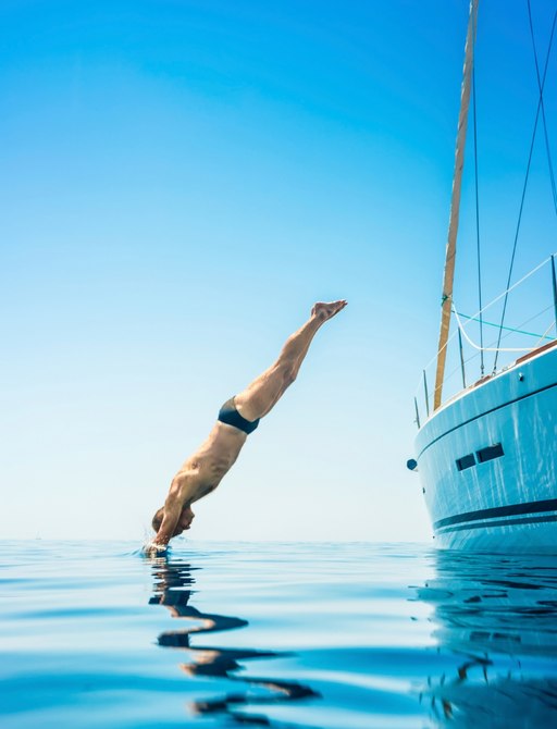 charter guests dives from luxury yacht