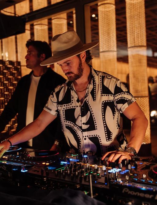 DJ spinning decks at Zuma Cannes