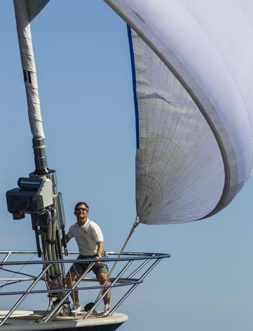 a man prepares his sailing yacht