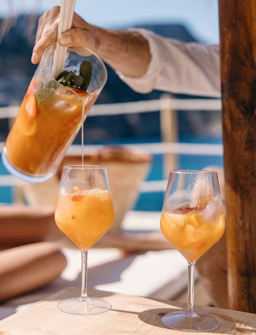 Cocktails being poured into two glasses