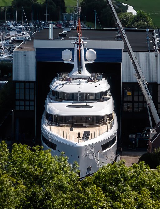 Overhead view of Feadship 'Project 822' being floated out of her construction shed at Kaag, Netherlands.