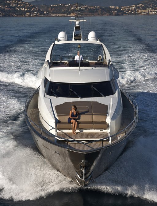guest relaxes on foredeck of motor yacht QUANTUM as she cruises through the French Riviera