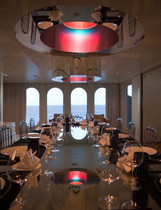 luxury motor yacht IDOL dining room with large windows to look out at sea