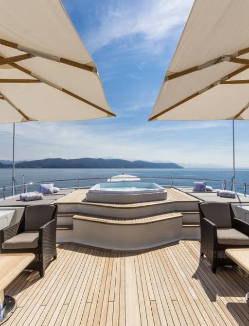 White parasols, seating and jacuzzi overlooking the Mediterranean on Ferdy