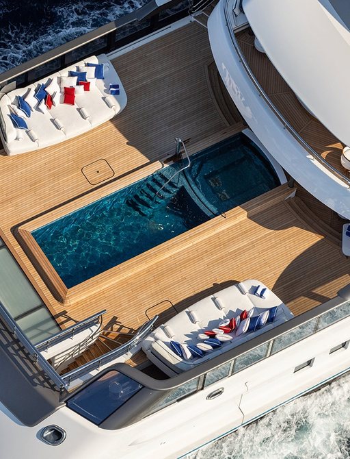 the large 12 metre swimming pool with two luxurious loungers at either side on the aft deck of lurssen's superyacht MADSUMMER