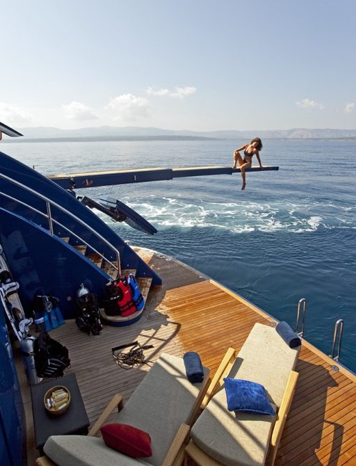 Charter guest enjoying the views from Mary Jean II's swim platform