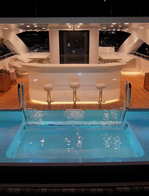 pool on sundeck of baba's yacht with bar and sunpads