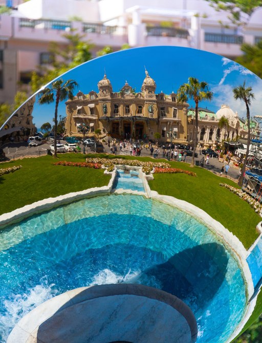 Reflection of Monaco casino and fountain