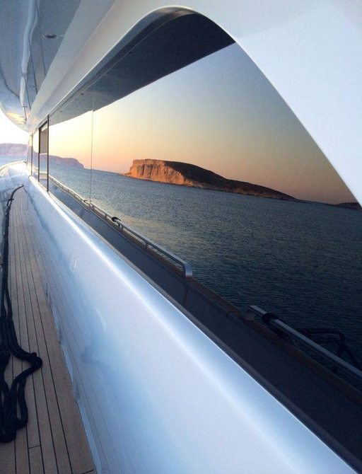 Sunset reflecting in side of charter yacht tropicana