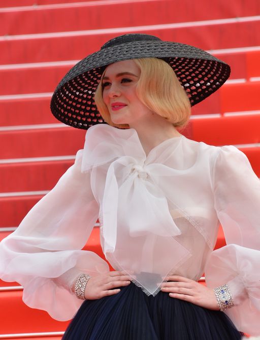 Elle Fanning posing for cameras on the red carpet at the Cannes Film Festival