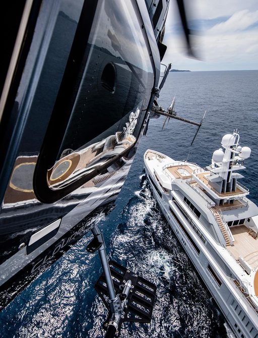helicopter in air after taking off from the helipad on board superyacht CLOUDBREAK 