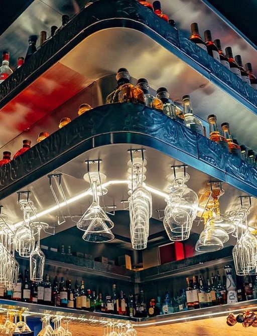 Upside down glasses on display at a bar