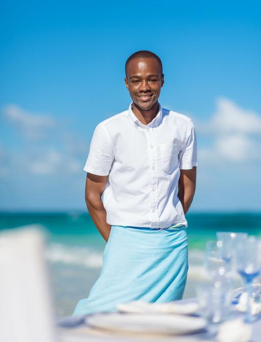 A smiling member of staff at the Thanda Island Resort