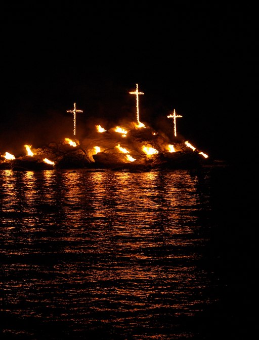 Cross on fire on Greek Island Santorini