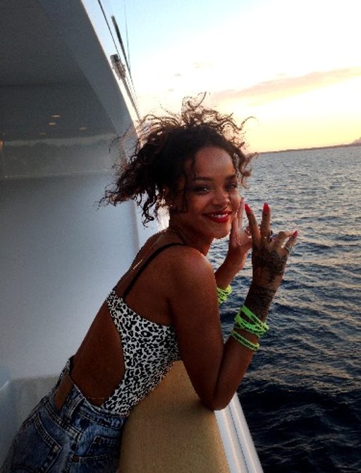 pop star rihanna on a superyacht showing support for cogs of cancer by wearing charity wristbands