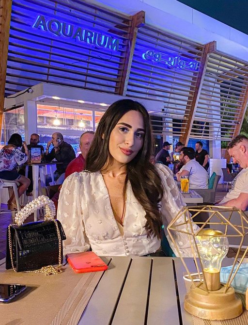 beautiful girl seated at a table at the Aquarium restaurant, yas marina, Abu Dhabi