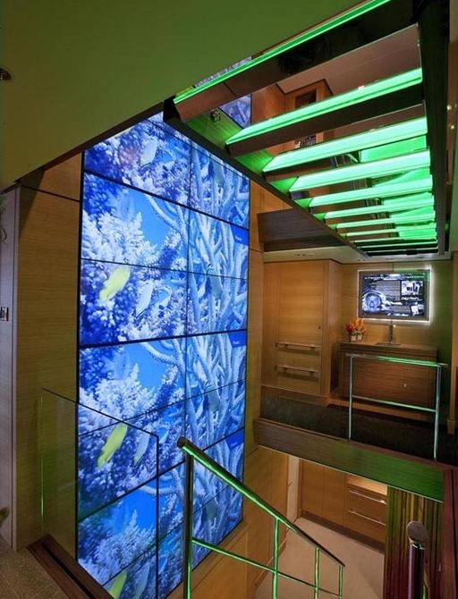 three-storey video wall and glass staircase aboard charter yacht Big Fish 
