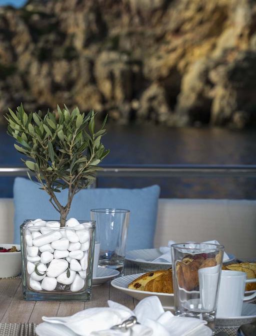 Close up of alfresco dining table set for breakfast on board superyacht RINI