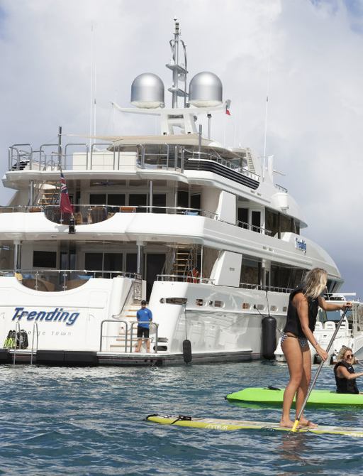 woman on kayak with superyacht backdrop