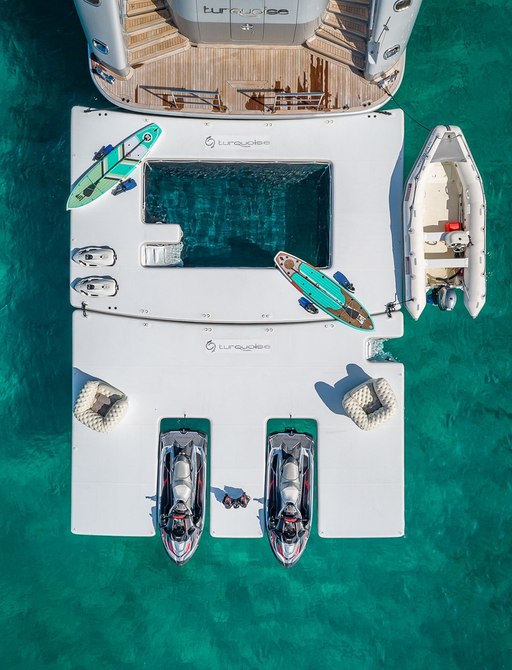 the aft deck of a luxury charter yacht with pool and water toys 