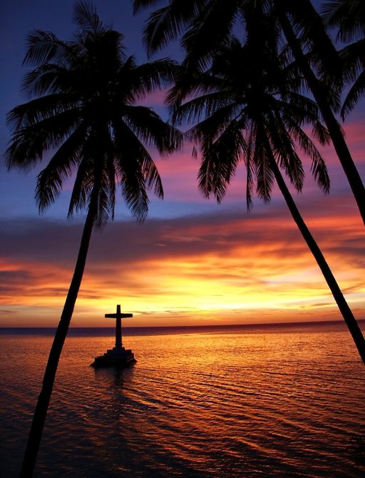 sun sets over a sandy beach in the Philippines with palm trees