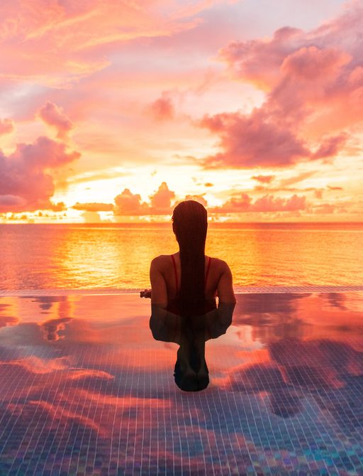 Woman looking out into the sunset on Caribbean yacht charter