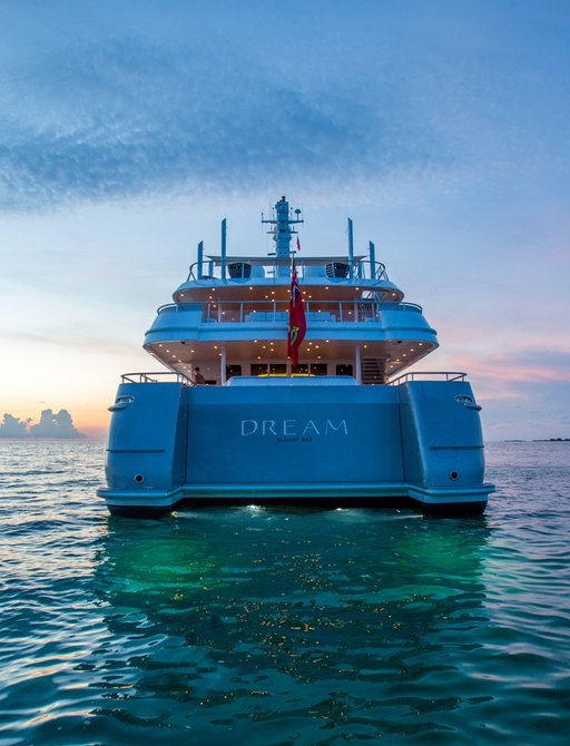 Aft view of motor yacht Dream at sunset at anchor on a luxury charter