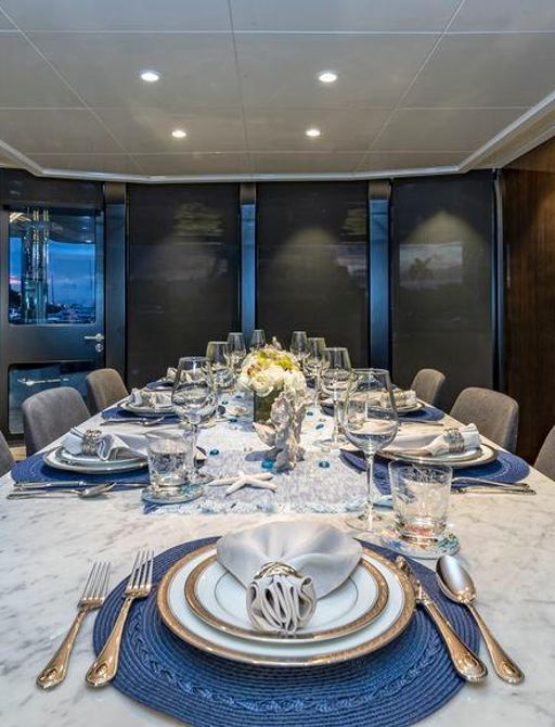 Fully laid dining table on superyacht OCULUS