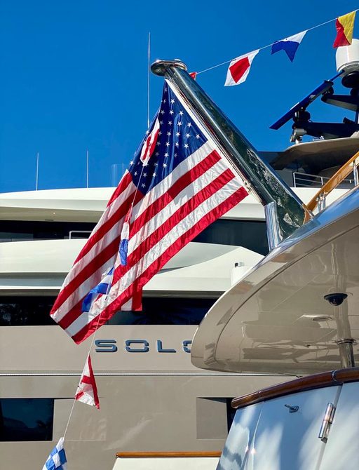 FLIBS 2019 luxury yacht SOLO with a flag in foreground