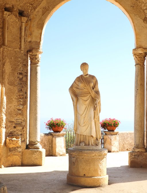 Ravello gardens statue beneath stone arches