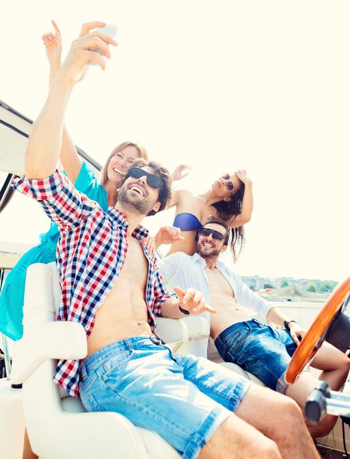 A young group taking a selfie on a yacht