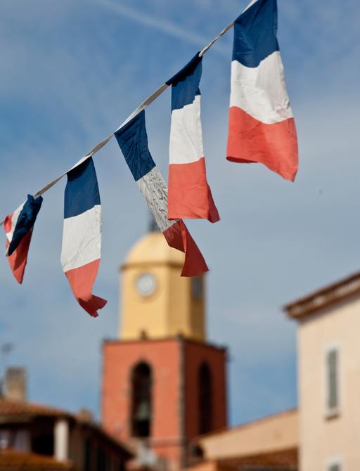 banner of French flags with tower in background
