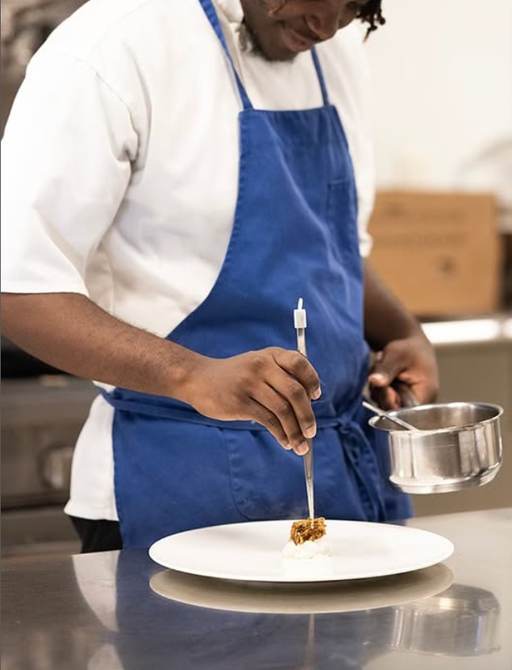 Chef at Blue Eleven plating premium cuisine