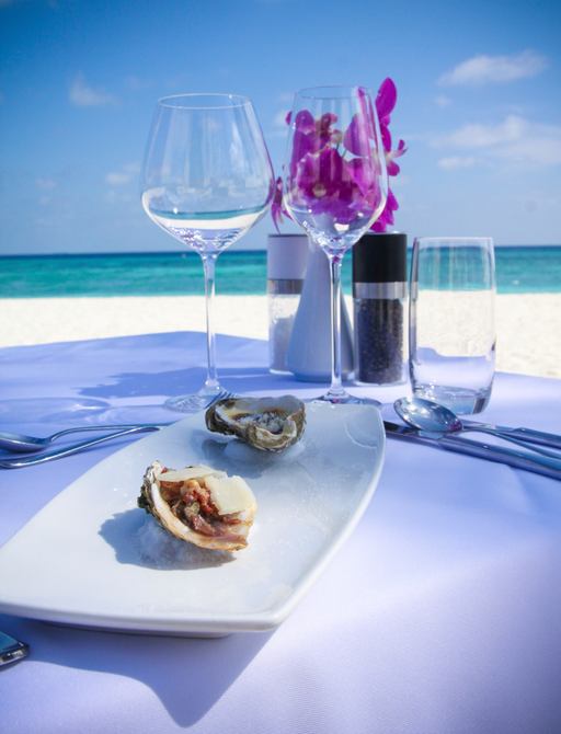 Table laid for fine dining on a tropical beach in Maldives