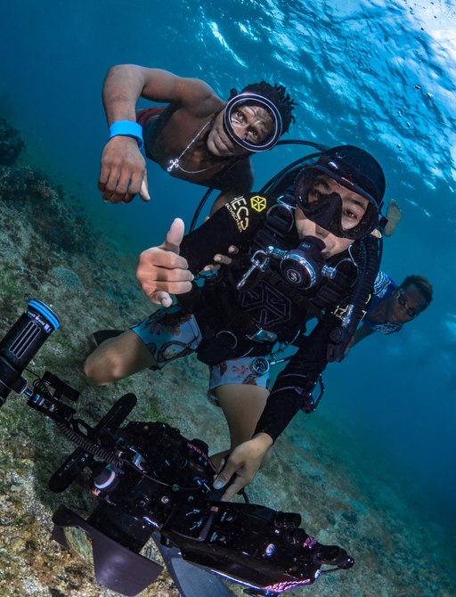 Witu Islands, Papua New Guinea, October 2nd 2019 - Film crew making scuba video with locals on coral reef
