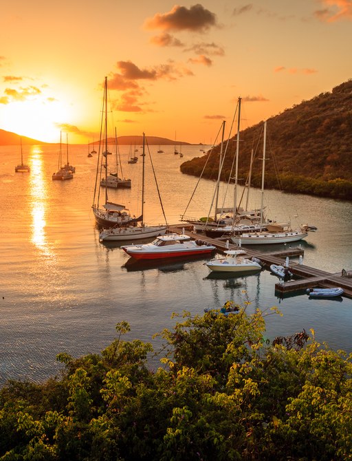 Yachts on pontoon at sunset in Caribbean