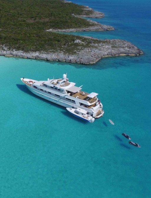motor yacht LIONSHARE anchors in an idyllic bay during a Caribbean yacht charter