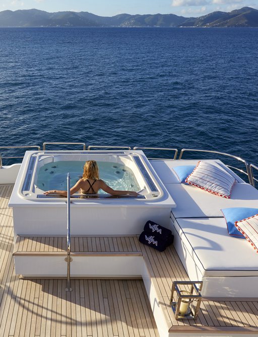 Female relaxing in Jacuzzi on Victoria Del Mar on sundeck with vast expanse of clear sea in front of her