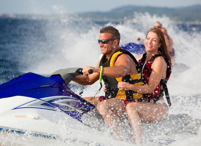 couple on jet-ski on yacht charter